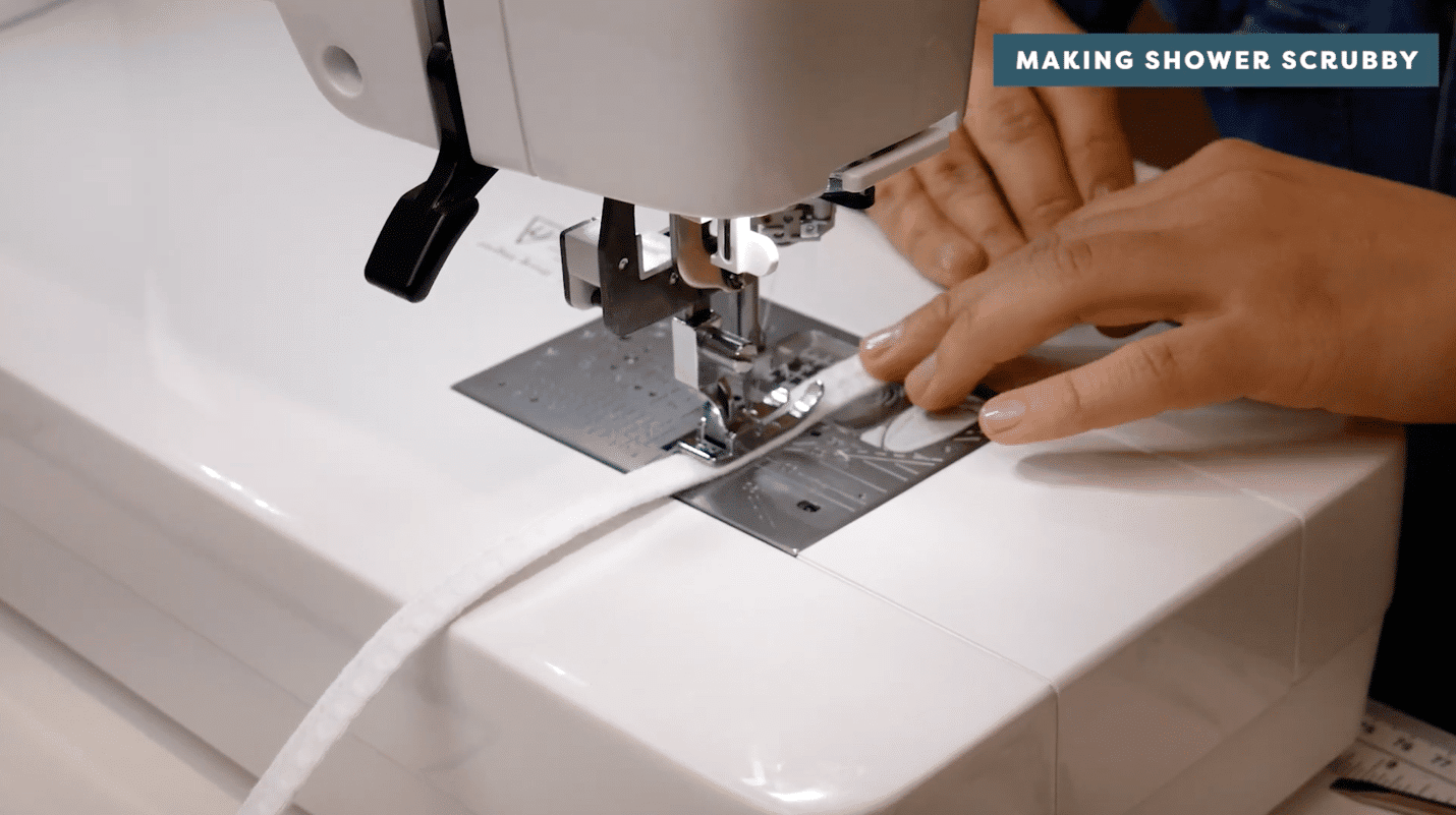 A picture containing sewing machine, appliance, indoor, person Description automatically generated