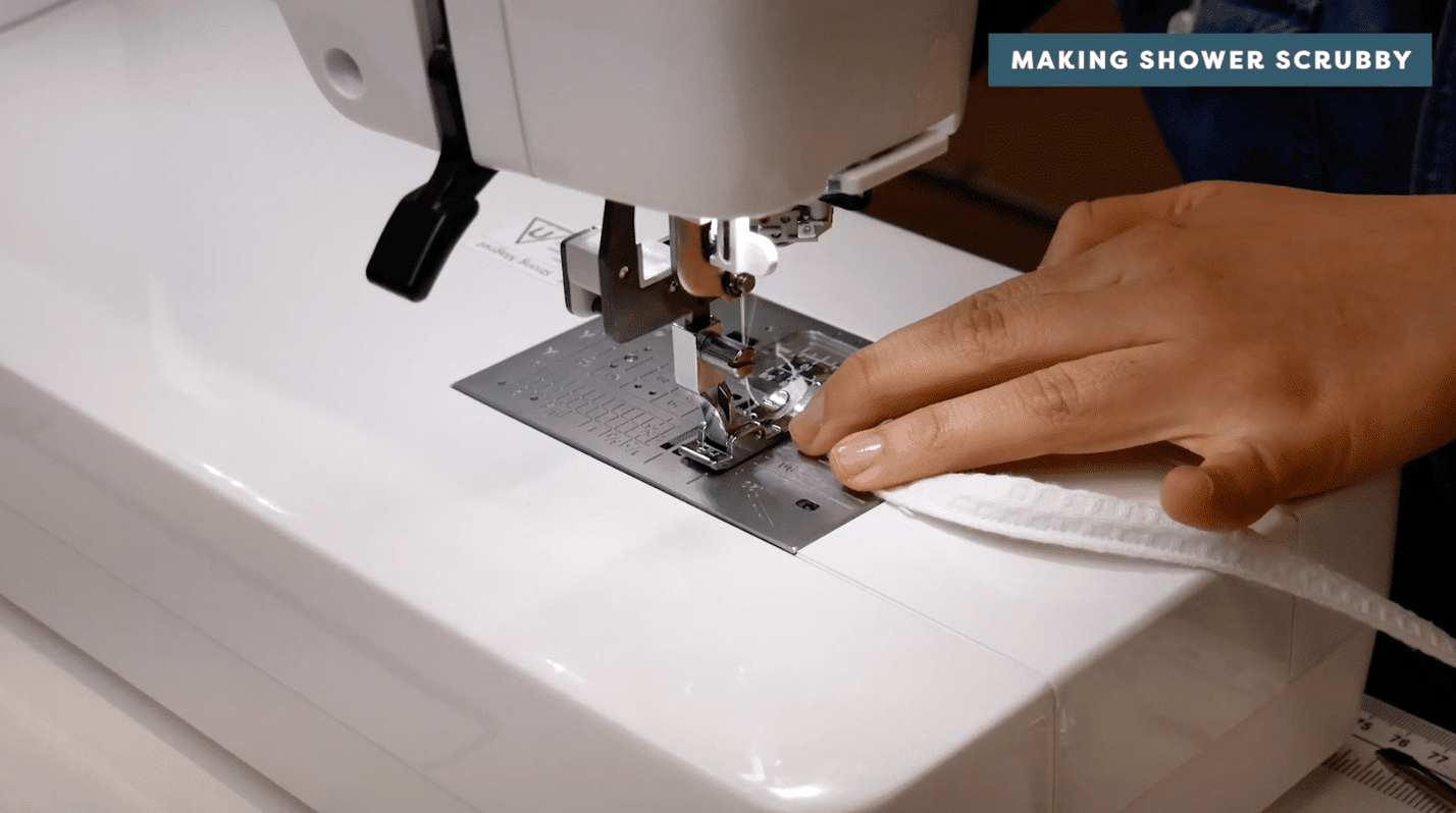 A picture containing sewing machine, appliance, person, indoor Description automatically generated